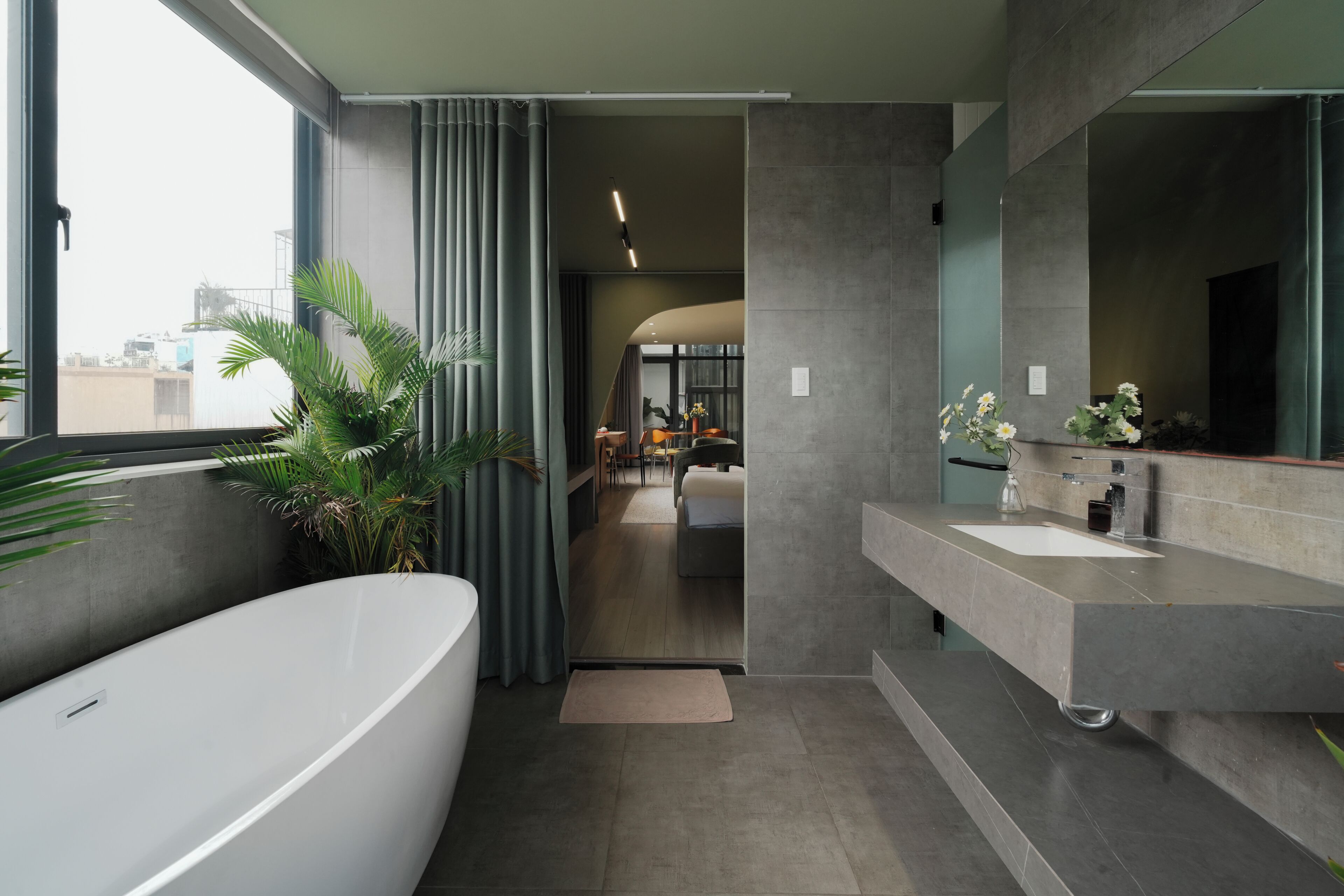 A modern bathroom with a bathtub, a sink, and a large mirror.