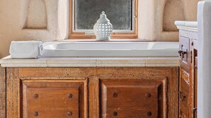 A kitchen with a window, wooden cabinets, and a white countertop. - Elegant Cobb House w/ Spa | Pond | Chef Kitchen (Kenwood)