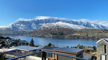 A lakeside view with snow-capped mountains in the background.