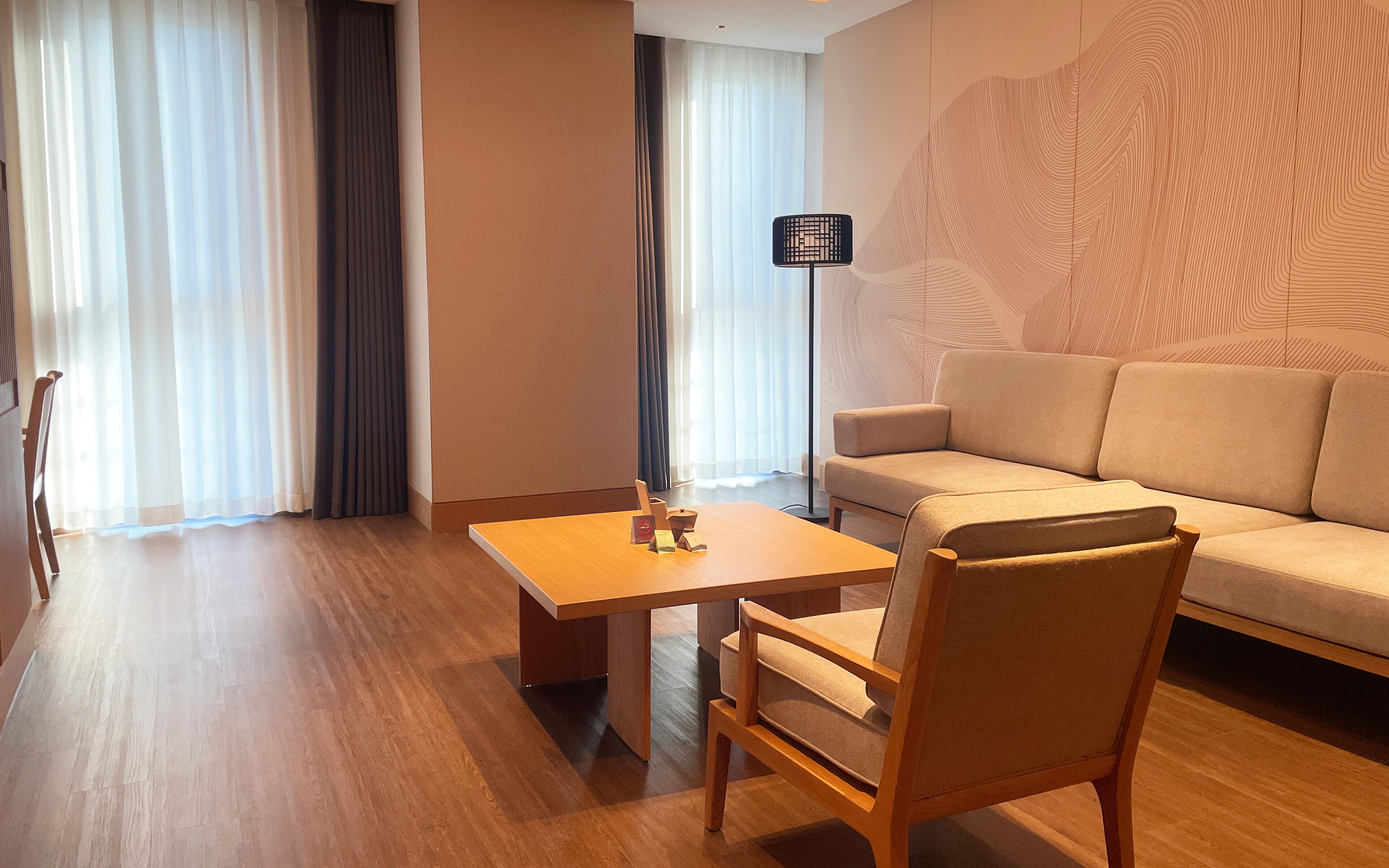 Een moderne woonkamer met een bank, een houten tafel en een stoel.