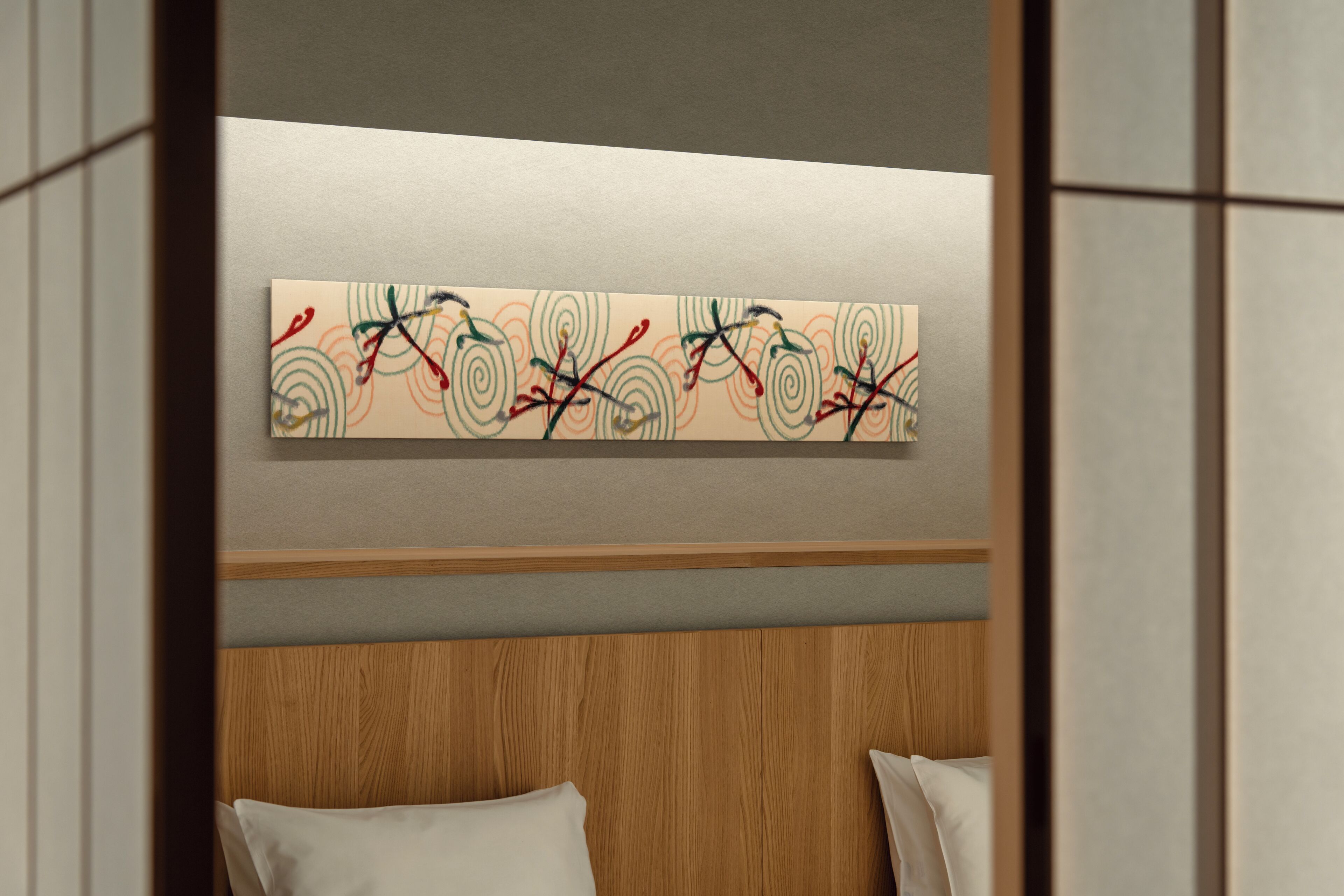A hotel room with a wooden headboard, a bed with white bedding, and a colorful abstract painting on the wall.