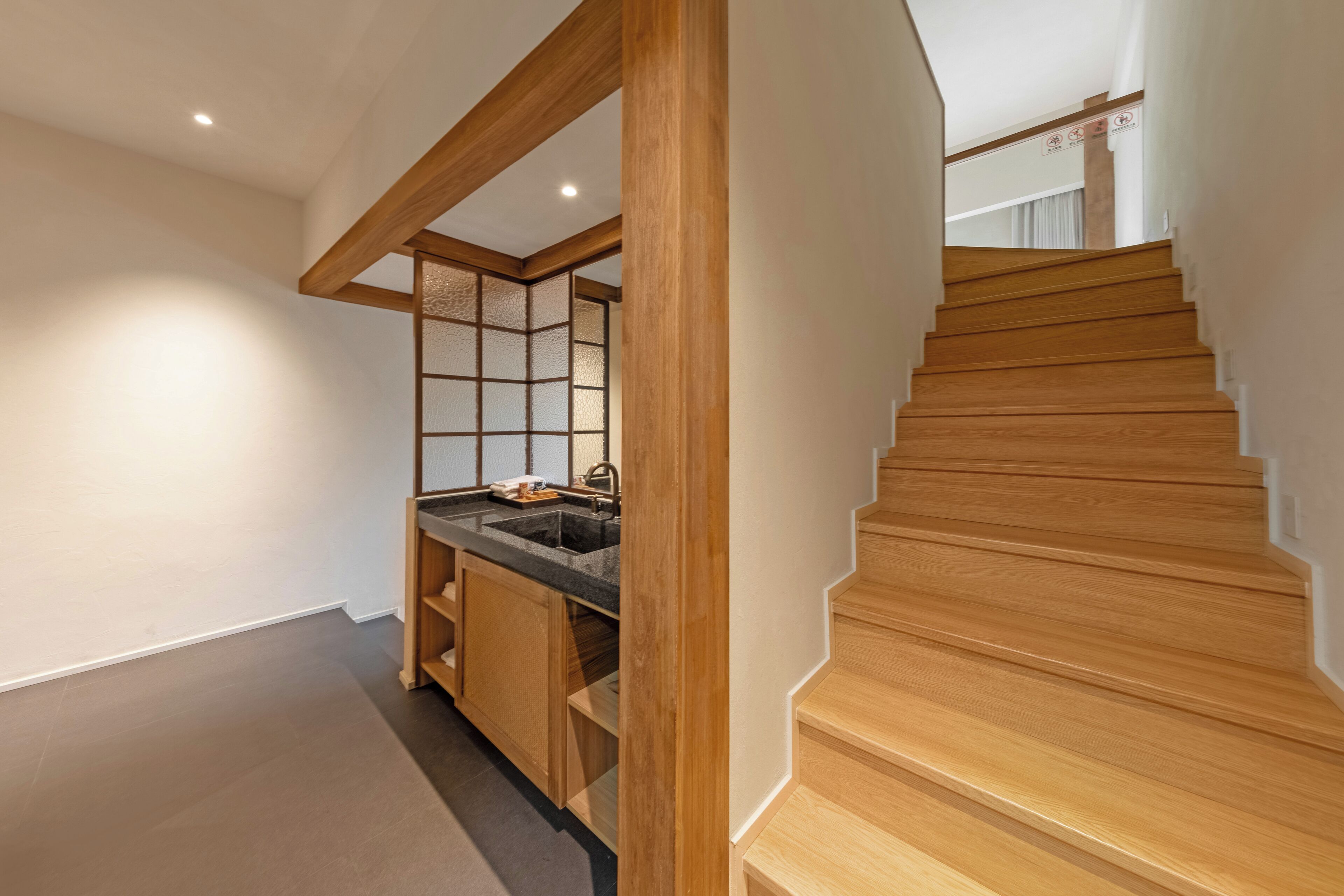 A modern kitchen with wooden cabinetry and a built-in sink.