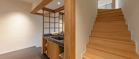 A modern kitchen with wooden cabinetry and a built-in sink.