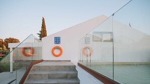 A modern outdoor staircase leading to a pool area with glass railings and orange lifebuoys on the wall. - Villa Hydraea, Garden Views, 2 BDR, Ptivate Pool, Furnished Terrace, Soroni (Rhodes)