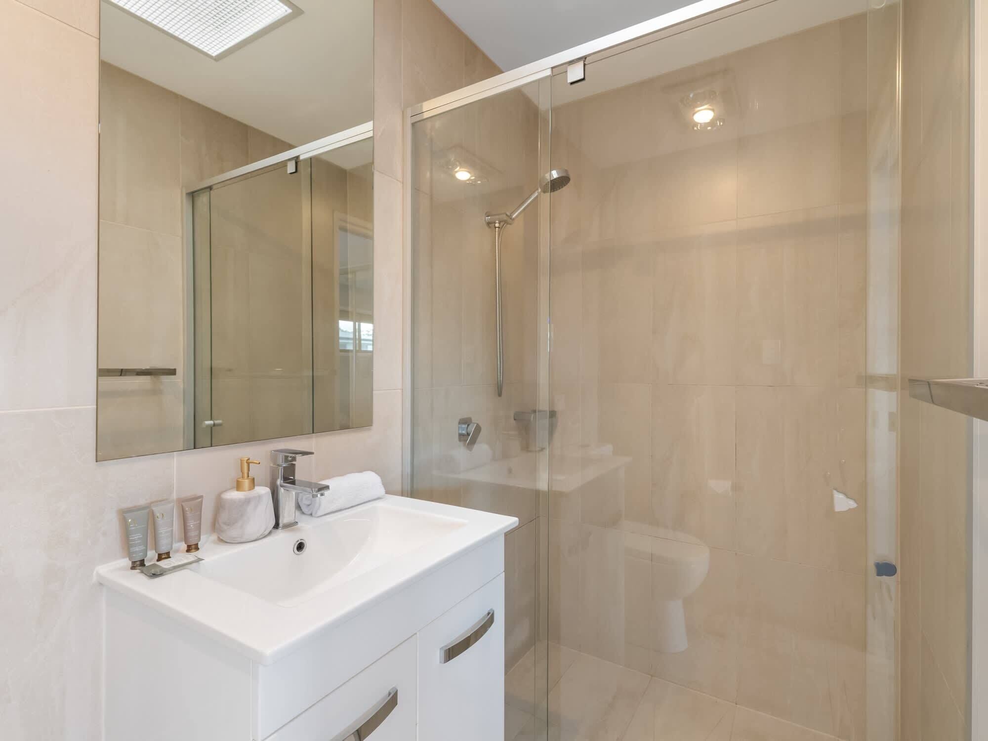 Shower, hair dryer, towels, shampoo