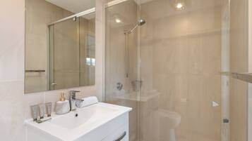 Shower, hair dryer, towels, shampoo