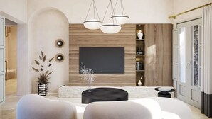 Een moderne woonkamer met een grote flatscreen-tv, een houten accentmuur en een zithoek met een ronde salontafel.