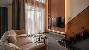 Una sala de estar moderna con un sofá, una mesa de centro y un televisor.
