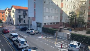 A multi-story residential building with a parking area in front. - M9 REST HOUSE VENICE (Mestre)