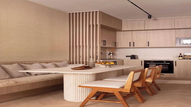A modern kitchen with wooden cabinets, a central island with seating, and a built-in stove. - Elegant apartment - AC- 2BR-6P- le Marais (Paris)