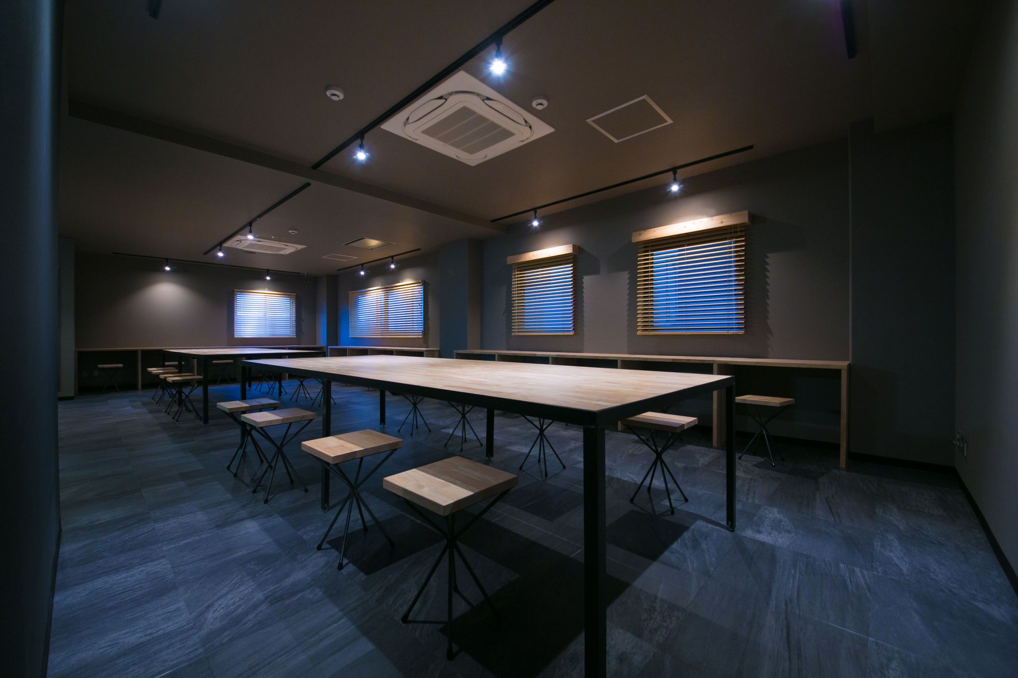 A conference room with a long table, multiple chairs, and built-in lighting.