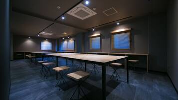 A conference room with a long table, multiple chairs, and built-in lighting.