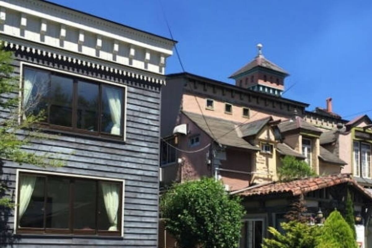 A building with a traditional architectural style, featuring a prominent tower and a large window.