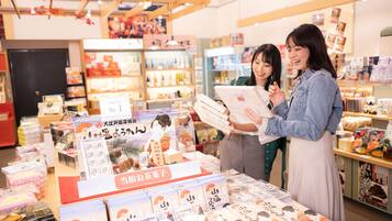 A bookstore with shelves stocked with books and a display table with book covers.