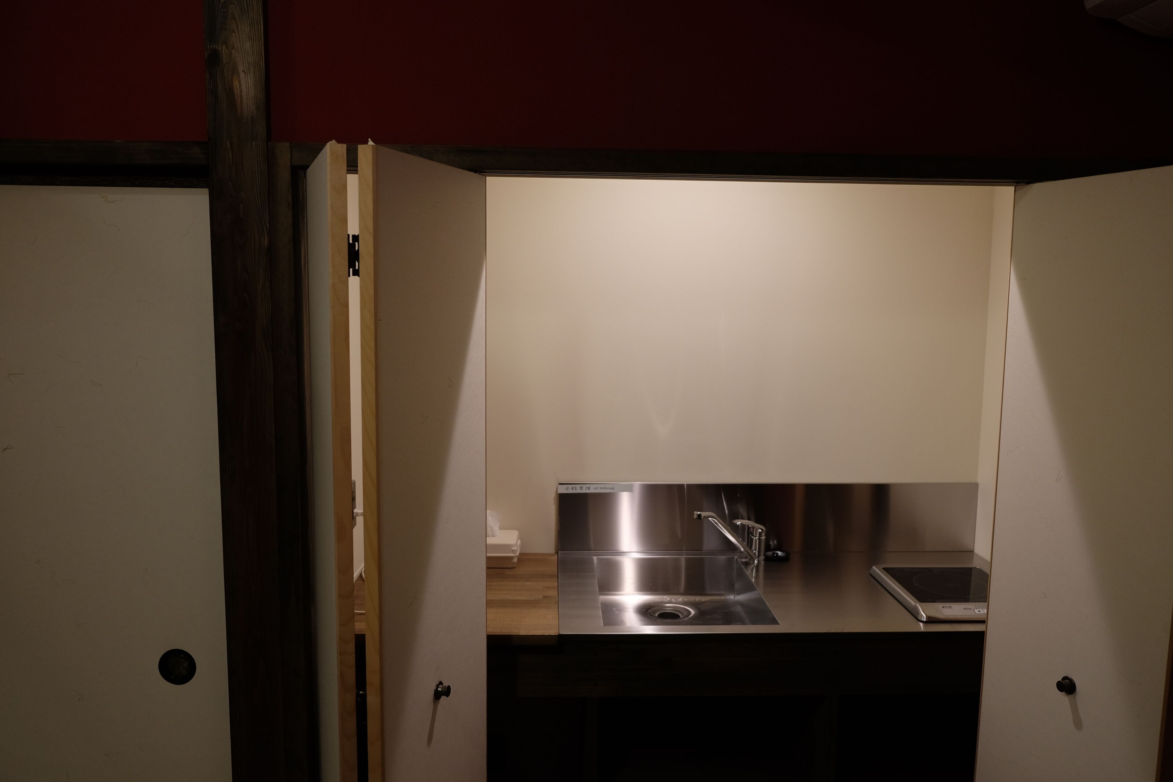 A compact kitchen with a stainless steel sink, a faucet, and a countertop.