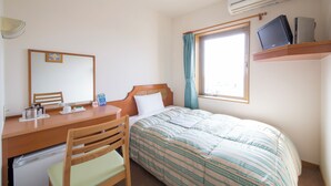 A bedroom with a bed, a desk, a chair, a small refrigerator, a window with curtains, and a mounted TV. - Hyper Hotel Komatsu (Komatsu)