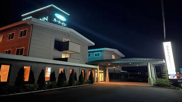 A modern hotel with a covered entrance and multiple windows.