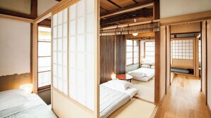 A traditional Japanese-style room with tatami flooring, sliding doors, and a low ceiling. - Araiya (Tokyo)