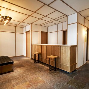 A room with a wooden counter, two stools, a bench, and a tiled floor. - Tassel Inn Kyoto Kawaramachi Nijo (Kyoto)