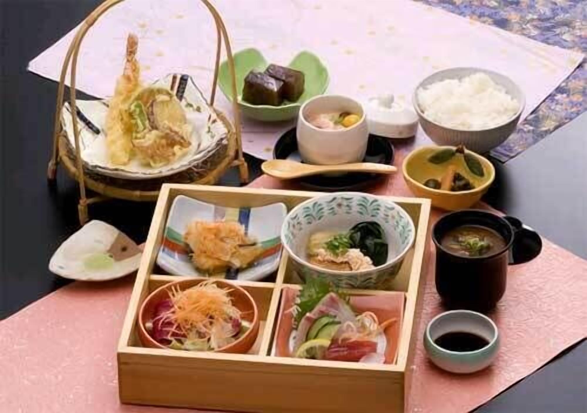 A traditional Japanese meal setup with various dishes and utensils.