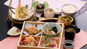 A traditional Japanese meal setup with various dishes and utensils.