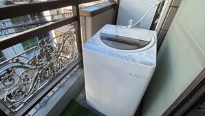 A washing machine on a balcony with a metal railing. - 3 Units Same Floor, 30sec Tsutenkaku/1 stop Namba2 (Naniwa-ku, Osaka City)