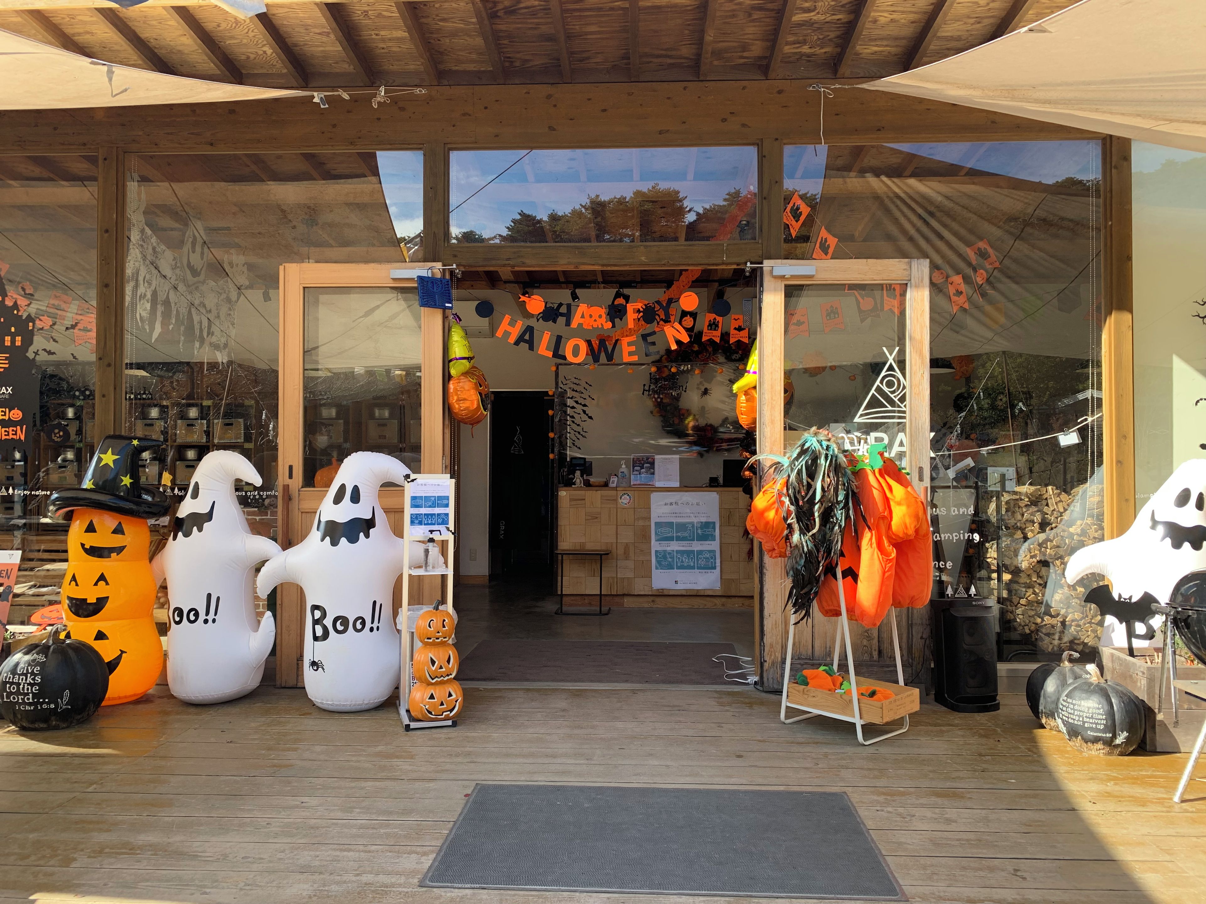 Fachada con decoraciones de Halloween, incluyendo figuras de fantasmas y calabazas.