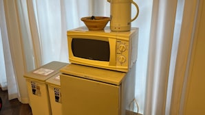 A kitchen area with a microwave, a coffee maker, and a small refrigerator. - 54 Journey Tokyo Akasaka (Tokyo)