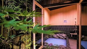 A traditional Japanese-style room with tatami flooring, a built-in shelf, and a small water feature. - Kyoran-gengetsu (Kyoto)