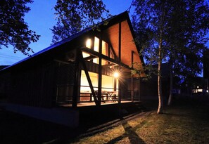 A modern wooden house with large windows and a porch. - Bliss Cottage Sakura (Kutchan)