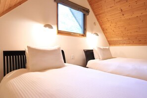 A bedroom with two beds, wooden ceiling, and a window with curtains. - Bliss Cottage Sakura (Kutchan)