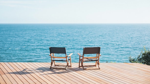 Two wooden chairs on a wooden deck overlooking a body of water. - Glamping Villa Sameya Awaji (Sumoto)