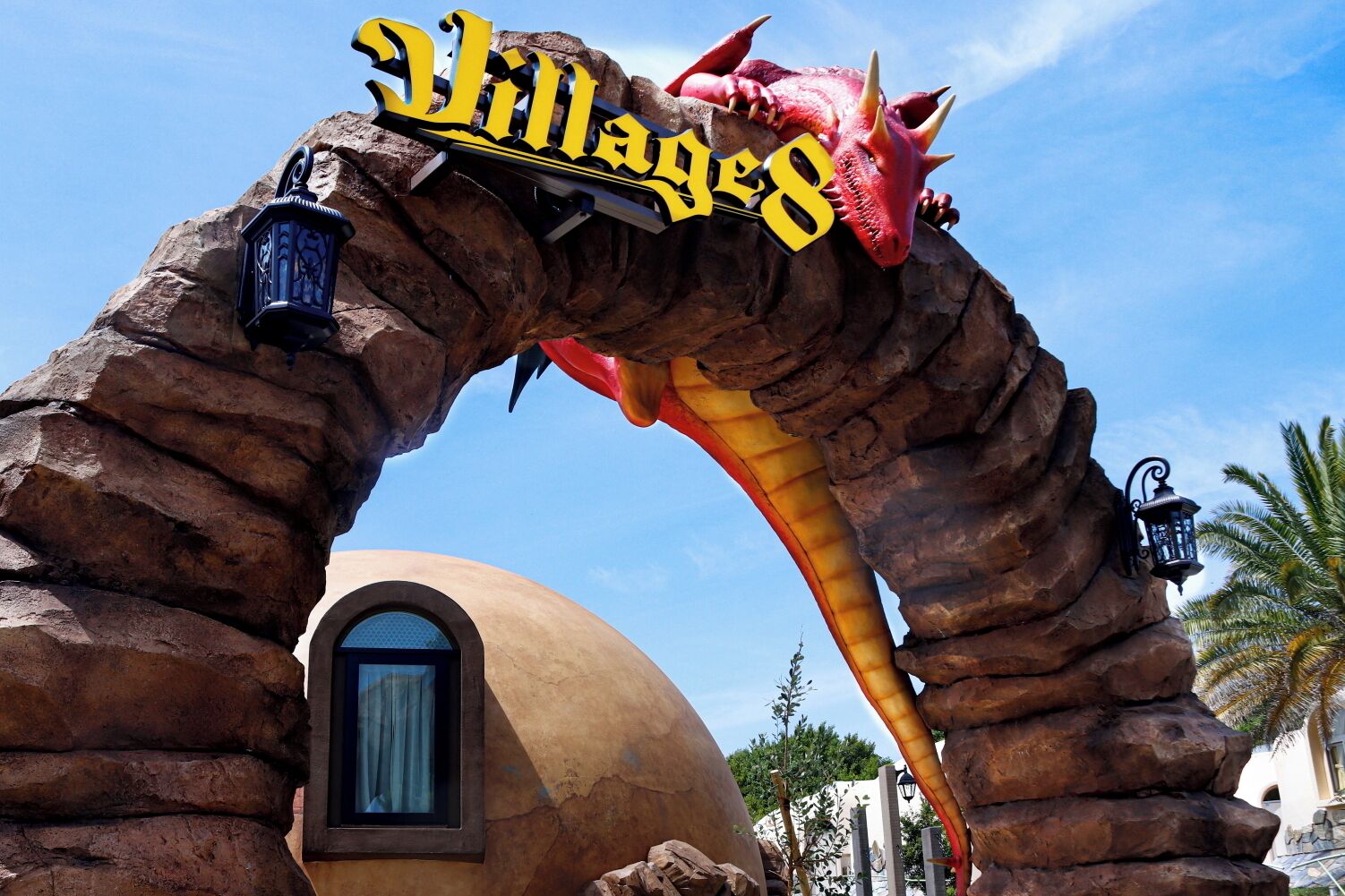 A rock archway with the text 'Villages' and a red dragon figure.