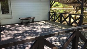 A wooden deck with a bench and a picnic table. - Heartland Hills in Noto 2 Ohiroma House (Shika)