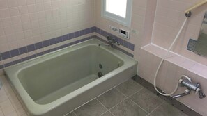 A bathroom with a bathtub, a shower, and a window. - Heartland Hills in Noto 2 Ohiroma House (Shika)