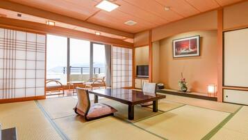 A traditional Japanese room with tatami flooring, a low table, and sliding doors.