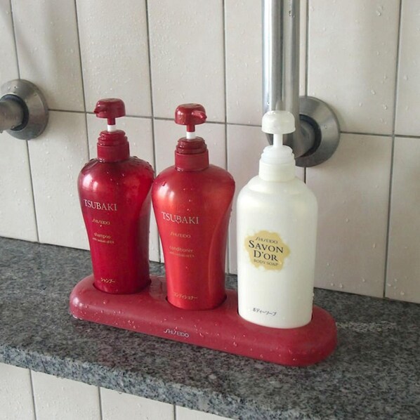 Three bottles of body soap on a countertop.