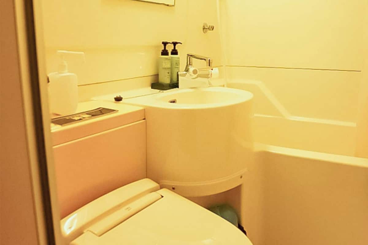 A small bathroom with a toilet, sink, and bathtub.