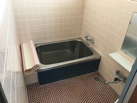 A bathroom with a bathtub, a shower, and a toilet.