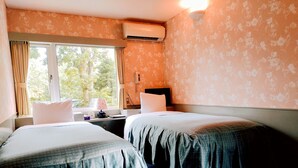 A hotel room with two beds, a window with curtains, an air conditioning unit, a bedside table with a lamp, and a wall-mounted phone. - Pension Schooner (Nasu)