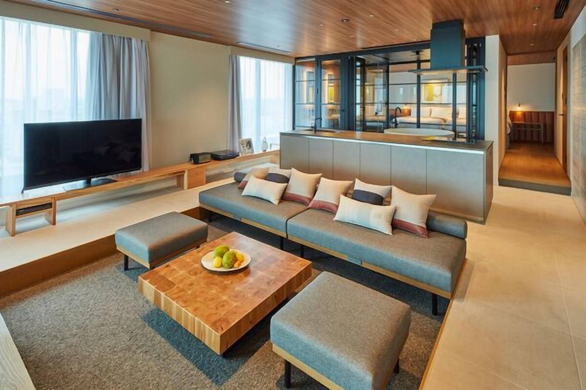 Een moderne woonkamer met een bank, salontafel en televisie.