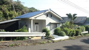 A single-story house with a sloped roof, a small porch, and a garage. - Diving & Pension Riki (Setouchi)