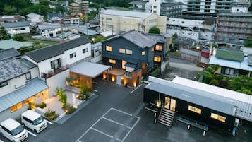 A multi-story building with a parking lot in front.