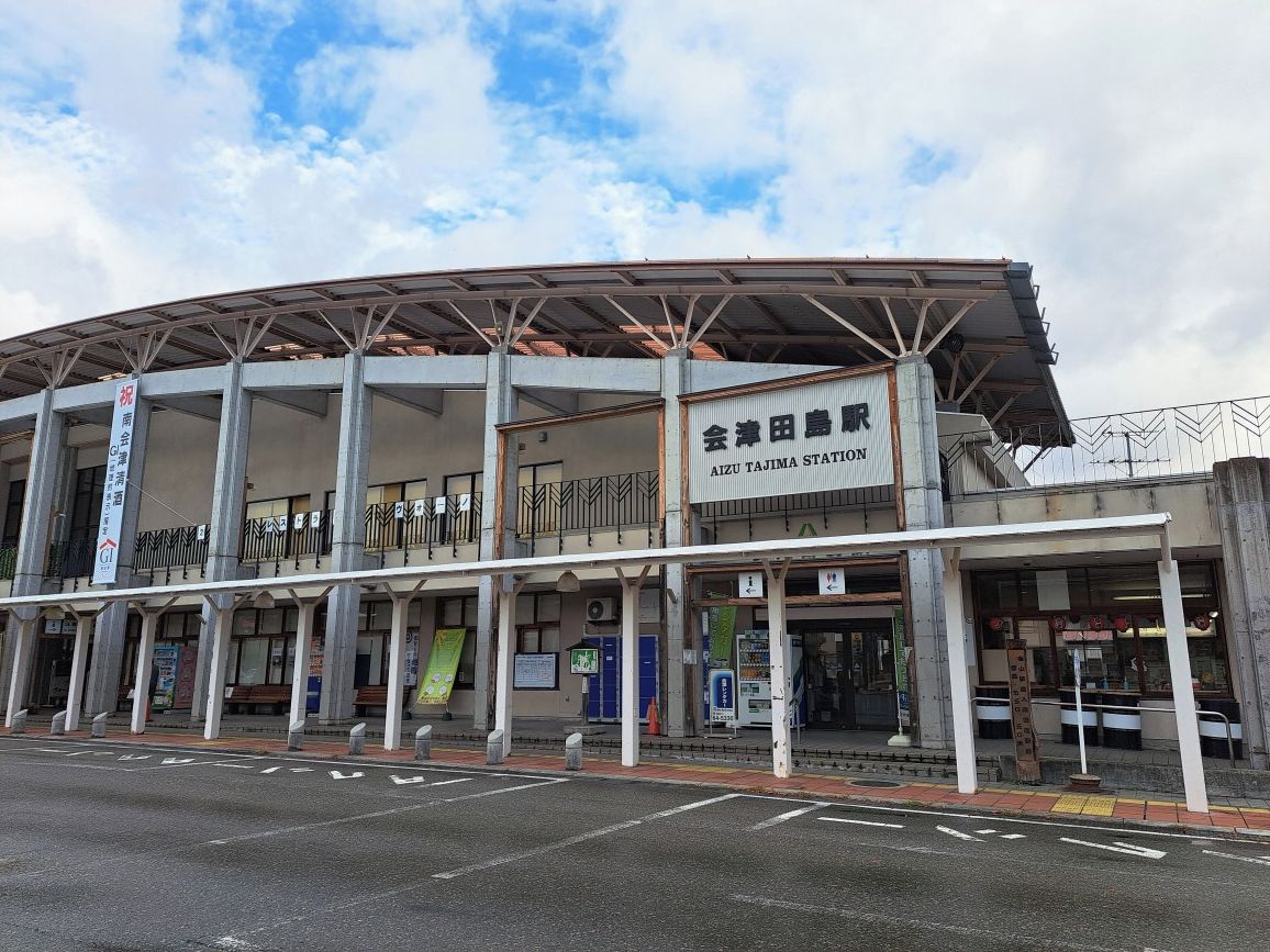 A train station with a covered platform and multiple ticket counters.