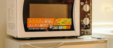 A microwave with a digital display and a Sharp brand label.