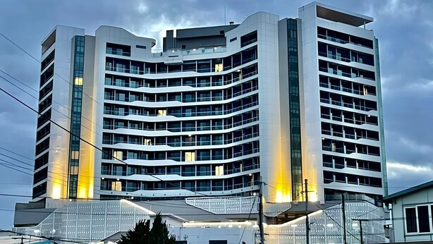 A modern multi-story building with a curved facade, large windows, and a glass entrance area. - Nova Stay Gangneung (Gangneung)
