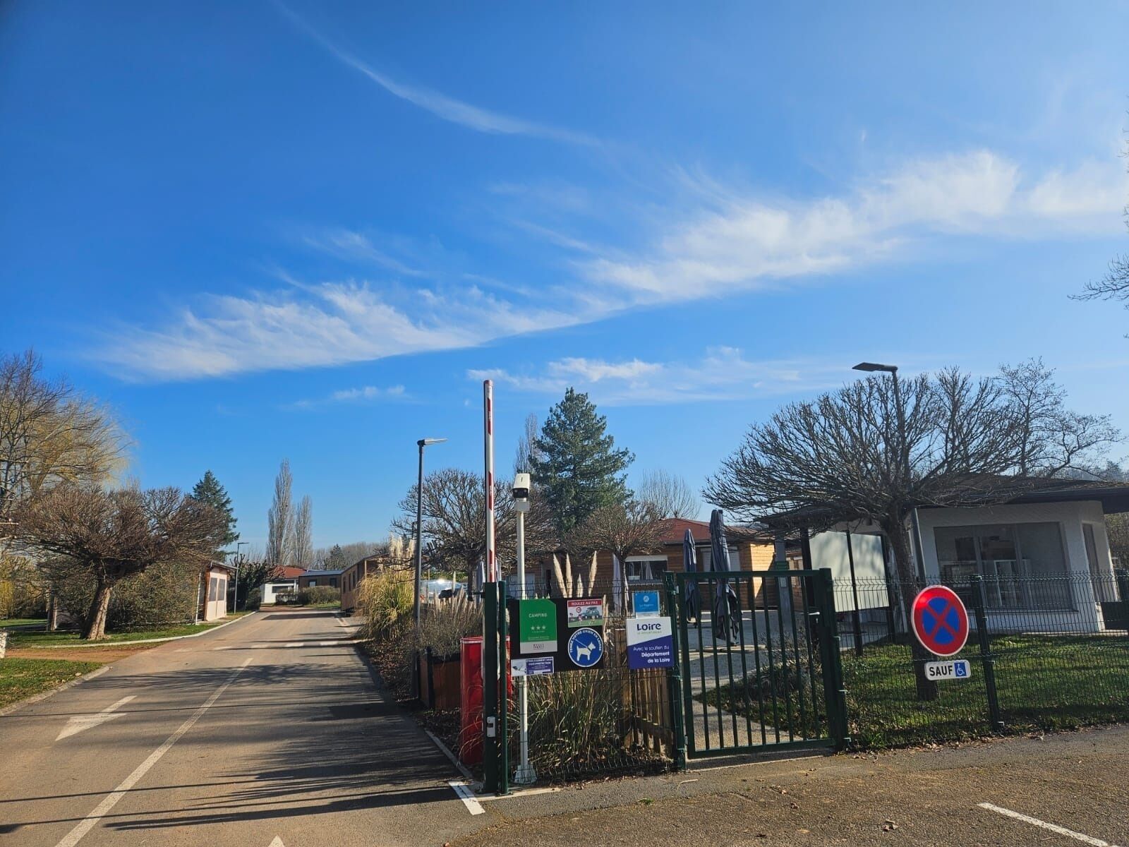 A gated entrance to a property with a clear sky.