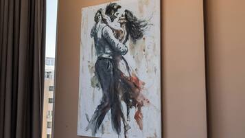 A painting of a couple embracing on a wall.