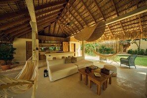 A spacious living area with a hammock, a sofa, and a coffee table. - 7 BEDROOM BUNGALOW WITH POOL & A/C, NEAR MACAO BEACH (Punta Cana)