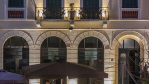 A hotel with a classic facade, multiple balconies, and outdoor seating areas. - Iliotropio Athens, Thisio (Athens)